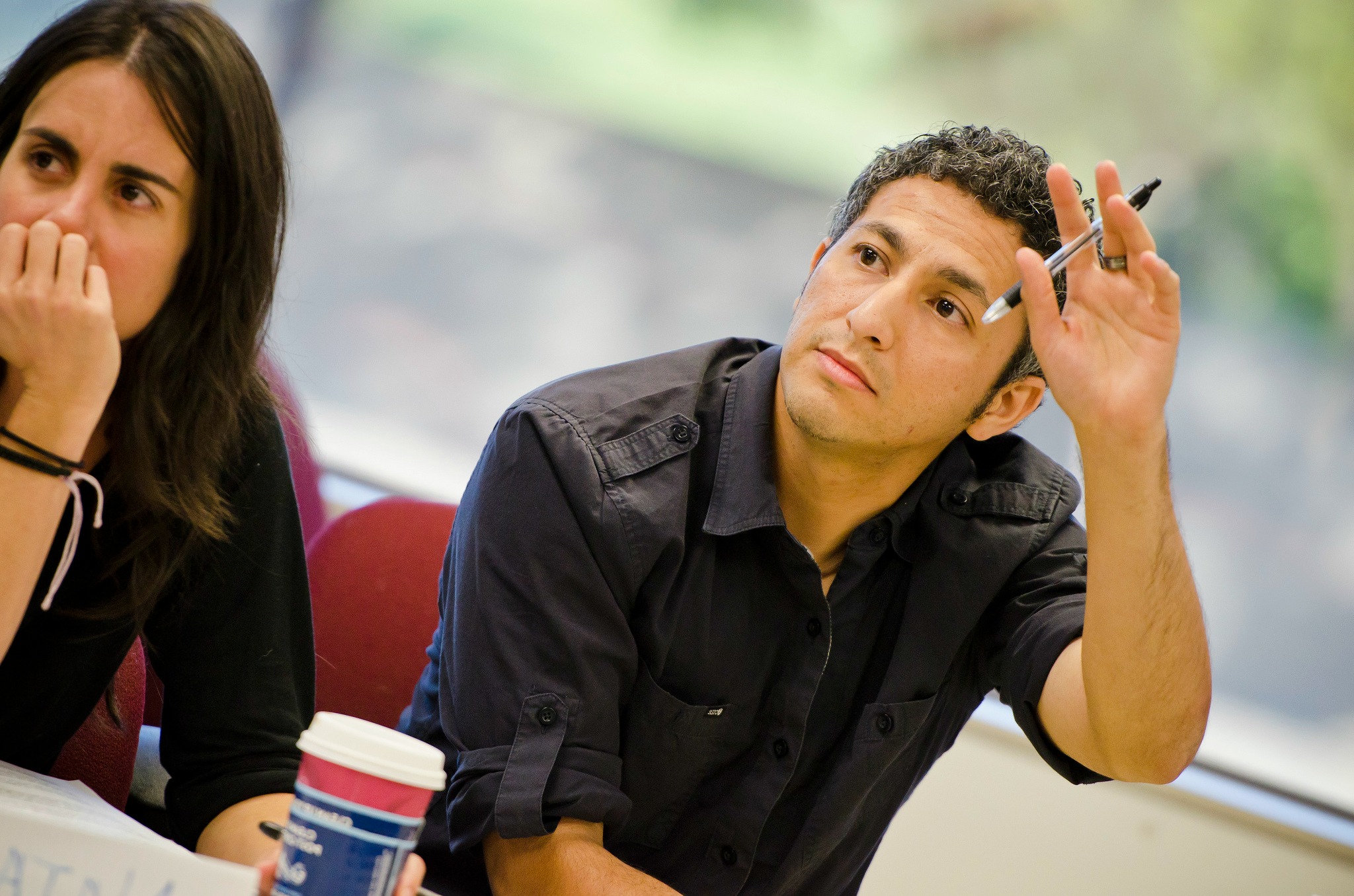 AppliedCOmmunityPsychology › Antioch University Students in class, one raising their hand