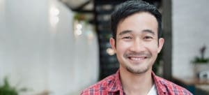 Smiling man in plaid shirt