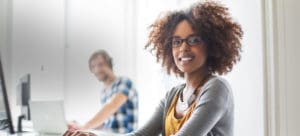 Smiling woman working on computer