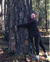 Greta Dragger, person hugging large tree.
