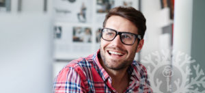 happy smiling man in glasses and plaid shirt