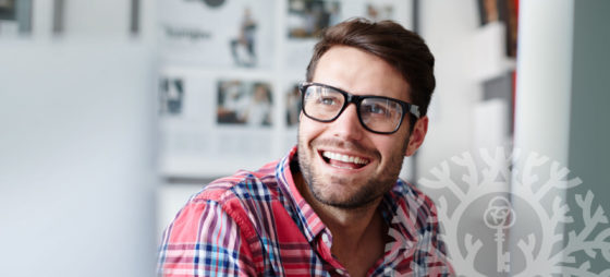 happy smiling man in glasses and plaid shirt
