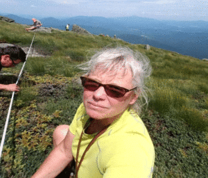 Micki › Antioch University Micki- sitting outside on mountain side