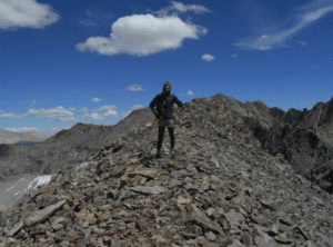 Timbo- Man standing on rocky mountain side