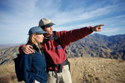 Two people on hike, man pointing into the distance