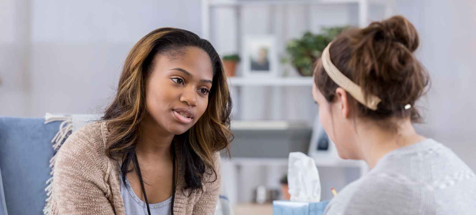 Therapy session , concerned looking counselor talking to patient
