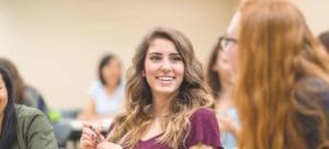 smiling student in class around piers