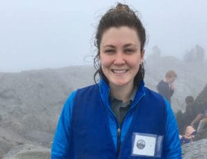 Emily pauses for a photograph while on mountain with other students.