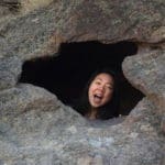 Iris smiling through a hole in some rocks