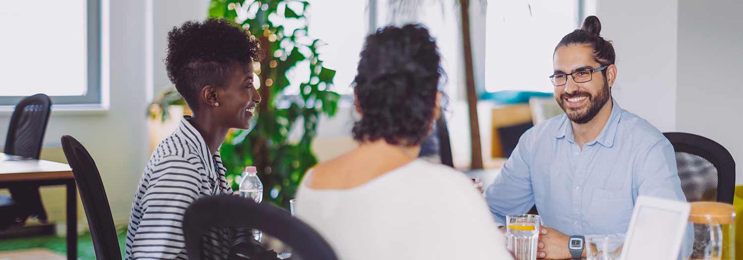 GettyImages-1005930956-hero › Antioch University Group meeting in bright office filled with plants