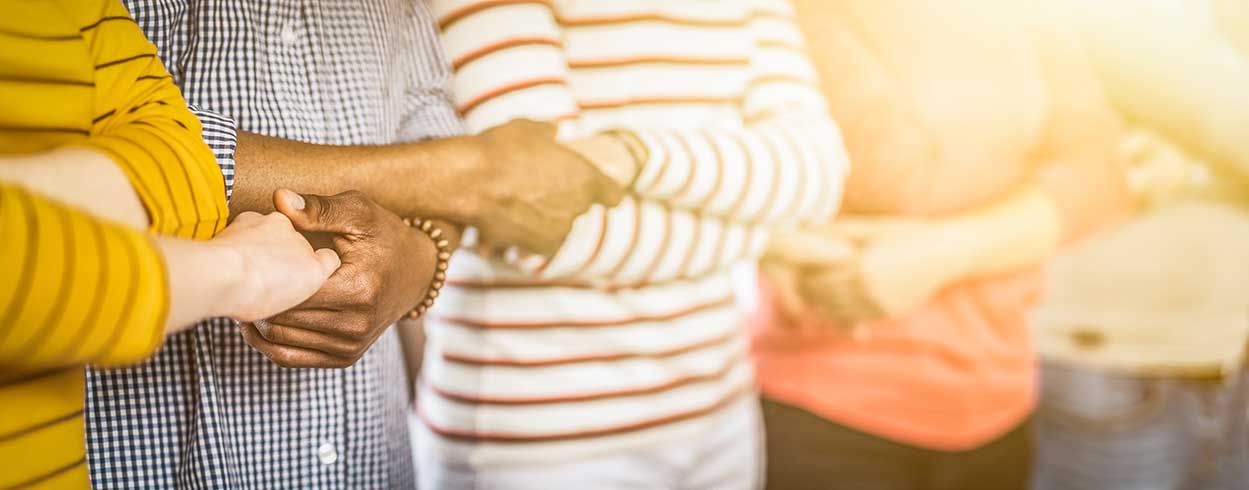 GettyImages-1159040738.jpg › Antioch University humans holding hands in chain formation