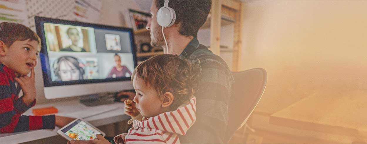 GettyImages-1216403165.jpg › Antioch University Individual working from home with children's near by