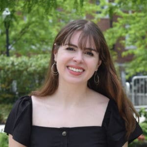 Headshot of Amanda smiling with trees in the background