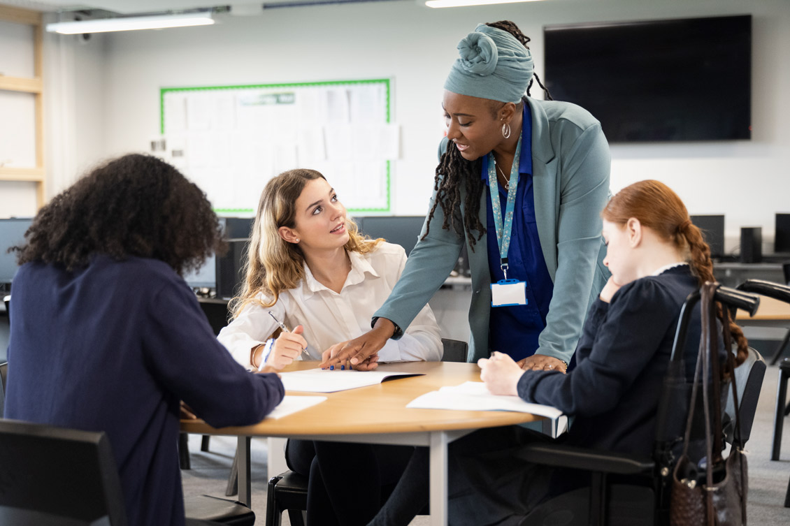 Students working with a teacher.