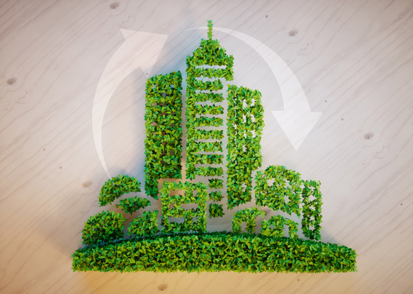 Green leafy buildings with recycling icon.