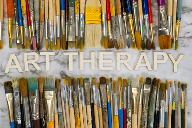 paint brushes and the words art therapy