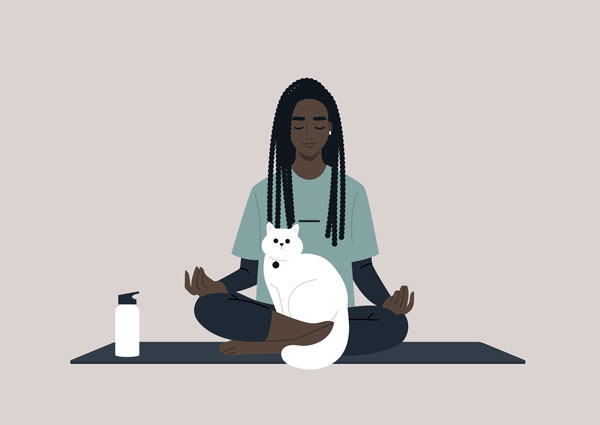 Person on yoga mat with a water bottle and a cat on their lap.