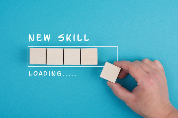 White writing on blue background, New Skill loading with wooden blocks in a rectangle to simulate loading bar on computer.