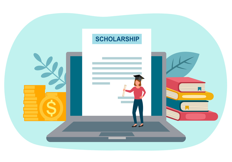 Scholarship › Antioch University A student writing a scholarship essay, focused on their laptop, surrounded by books and notes in a quiet study environment.