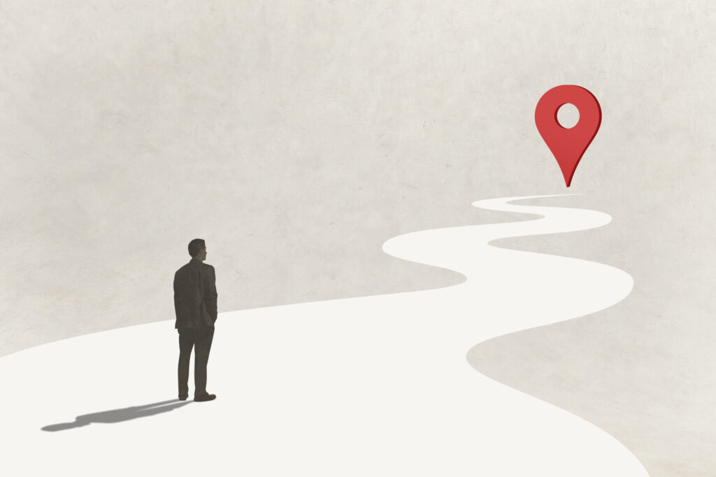 Man Looking Down Winding Path Toward Map Pin Icon › Antioch University