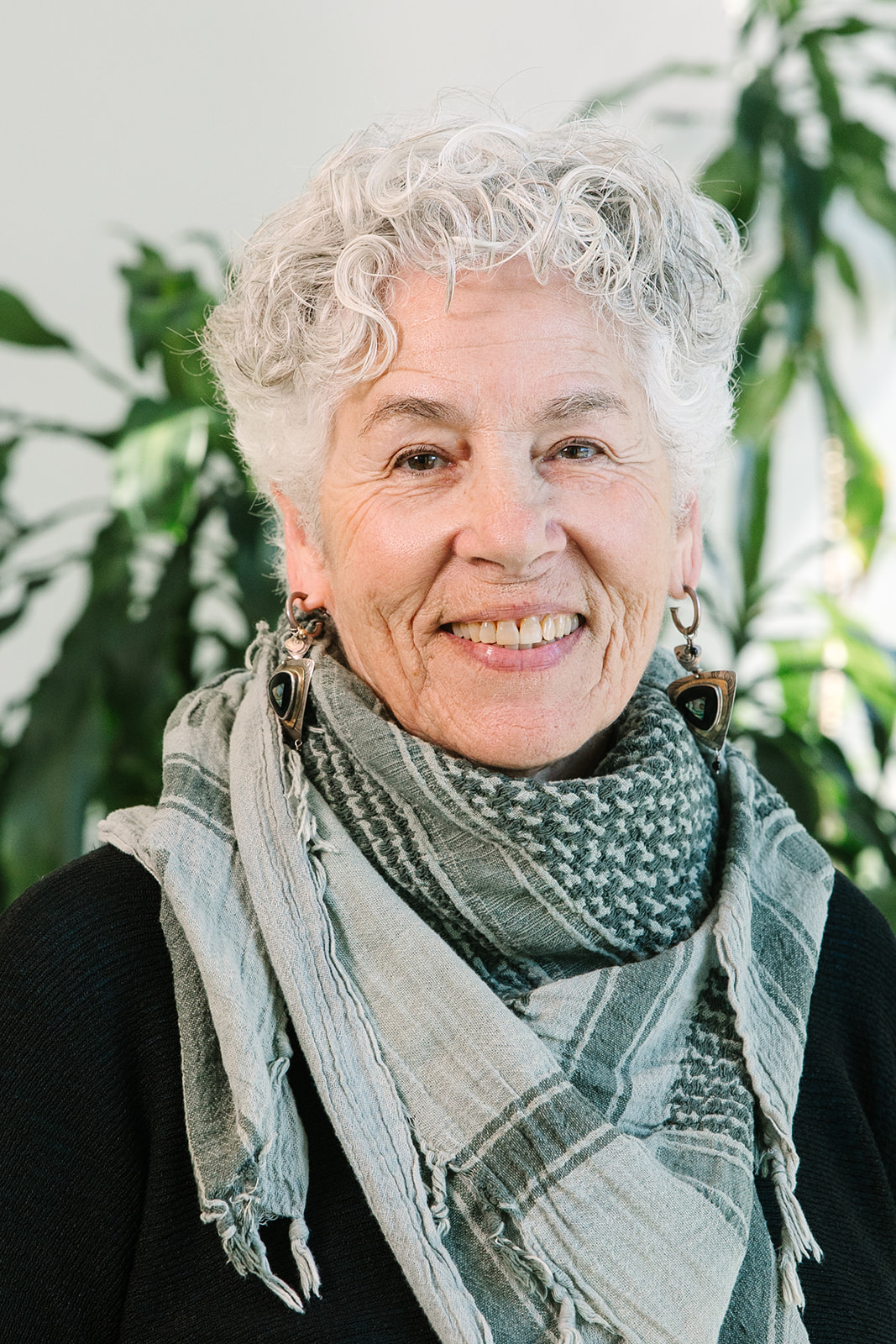 A headshot of Laurien Alexandre, who is wearing a scarf.