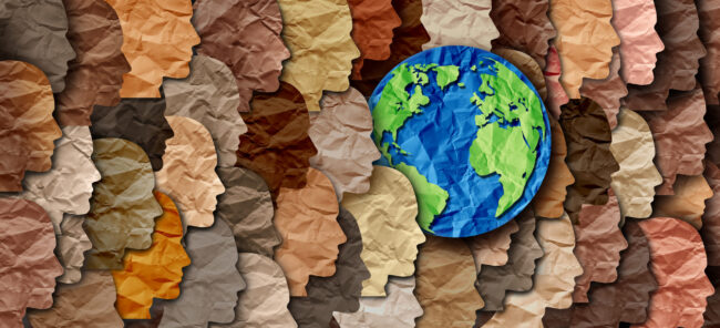 Earth globe surrounded by a crowd of multicolored paper silhouettes representing diversity around the planet